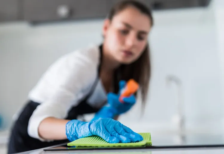 young-smiling-woman-cleans-kitchen-her-home.jpg